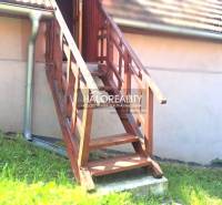 Wooden stairs leading to the veranda of the cottage in Hontianske Trsťany.
