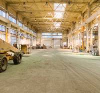 Spacious warehouses and halls with high ceilings and industrial lighting.