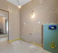 Interior in a family house prepared for the installation of a sink and toilet.