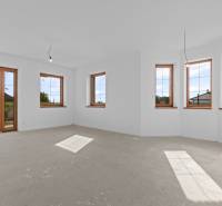 A bright room with large windows in a family house, view into the garden.