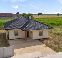 A family house on Fialková Street in Veľký Grob, surrounded by fields and a garden.
