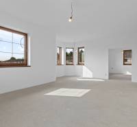 Spacious, unfurnished room with ceiling lights in a family house.