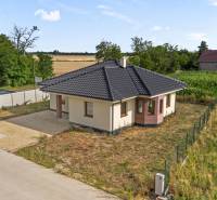 A family house on Fialkova Street in Veľký Grob, surrounded by fields and greenery.