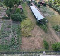 Aerial view of rural gardens and agricultural buildings in Štrkovec.