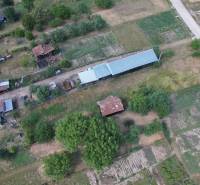 Visible construction of houses in Štrkovec with agricultural fields and buildings.
