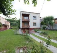 A family house in Dolná Mariková with a blooming garden and a manicured lawn.