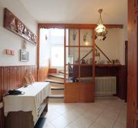 A hallway in a family house with wooden paneling and decorations on the walls.