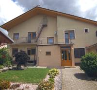 A family house on Športová Street in Brodské with a lawn and a flower garden.