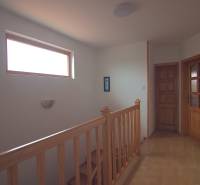 Wooden staircase with a window and doors in a family house, interior space.