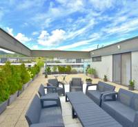 Terrace of a 4-room apartment on Pri vinohradoch Street in Bratislava - Rača with comfortable seating.