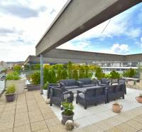Rooftop terrace of a 4-room apartment on Pri vinohradoch, Bratislava - Rača, with seating and greenery.