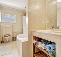 A bathroom with a bathtub, sink, and towels suitable for a 3-room apartment.