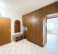 Entrance hall of a 2-room apartment with a large wardrobe and tiles.