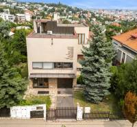 A family house on Mudroňova Street in Bratislava - Staré Mesto with greenery in the background.