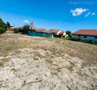 Plots - living in Veľký Meder, with a view of the blue sky and rooftops.