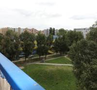 View from the balcony in Bratislava - Podunajské Biskupice on Kazanská Street, surrounded by greenery.