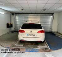 A car parked on a turntable in the garage.