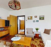 Living room in a family house with a sofa, table, carpet, and furniture.