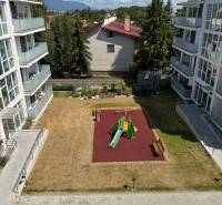 The courtyard between apartment buildings on Hurbanova Street in Poprad with a children's playground and benches.