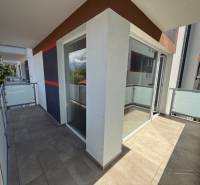 A balcony in a 3-room apartment on Hurbanova Street in Poprad with glass railings.