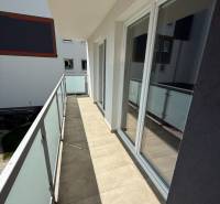 A balcony with tiles and sliding glass doors in a 3-room apartment on Hurbanova Street in Poprad.