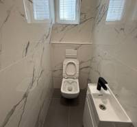 Bathroom with toilet and sink in a 3-room apartment.