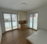 Bedroom with built-in wardrobes and a balcony in a 3-room apartment.