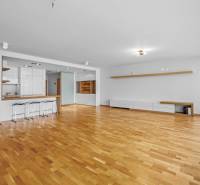 A spacious living room with a bar counter and wooden flooring, 3-room apartment.