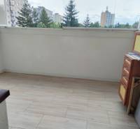 A glazed balcony with a view of the housing estate from a 2-room apartment.