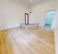 An office interior with a light floor and white walls, ready to be furnished.
