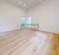 An empty room with wooden flooring and white walls, office.