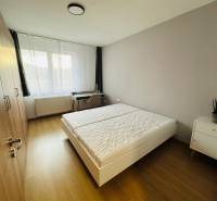 Bedroom in a 2-room apartment with a double bed, wardrobe, and nightstand.
