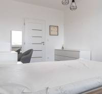 Bedroom with a bed, wardrobe, and armchair in a 3-room apartment.