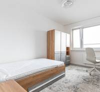 A bright room in a 3-room apartment with a wardrobe, bed, and desk.