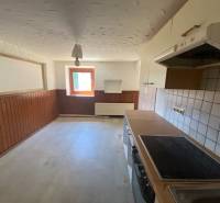 A kitchen with wooden paneling and tiles during renovation, Apartment construction.
