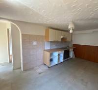 A kitchen space in the process of apartment construction with simple furnishings.