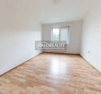 A spacious room with a wooden floor and a window in a 3-room apartment.