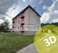 Exterior of an apartment building in Hnúšťa with a 3-room apartment and green surroundings.