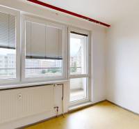 Two-room studio apartment with a balcony, plastic windows with blinds, empty room and radiator.