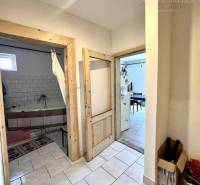 Interior of a family house with entrance to the bathroom and white tiles.