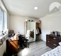 Bedroom in a family house with a desk and a wardrobe.