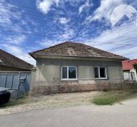 A family house in Horné Saliby with a traditional roof and simple facade.