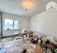 Renovation work in a family house, a table with building materials, a ladder, unfinished flooring.