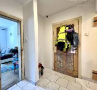 The interior of a family house with wooden doors and tiled floor.