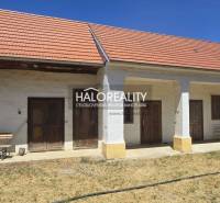 A family house in Váhovce with a gable roof and a garden on a sunny plot.