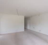 A spacious room with white walls and lighting preparation in a 2-room apartment.