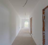 A spacious hallway in a 2-room apartment with bare walls and unfinished surfaces.