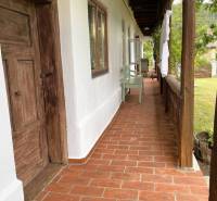 Traditional porch of a family house in Pányok with wooden doors and tiles.
