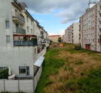 The exterior of apartment buildings on Jilemnického Street in Stupava, next to a green area.