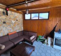 Stone wall and wooden interior with a sofa in a 2-room apartment.